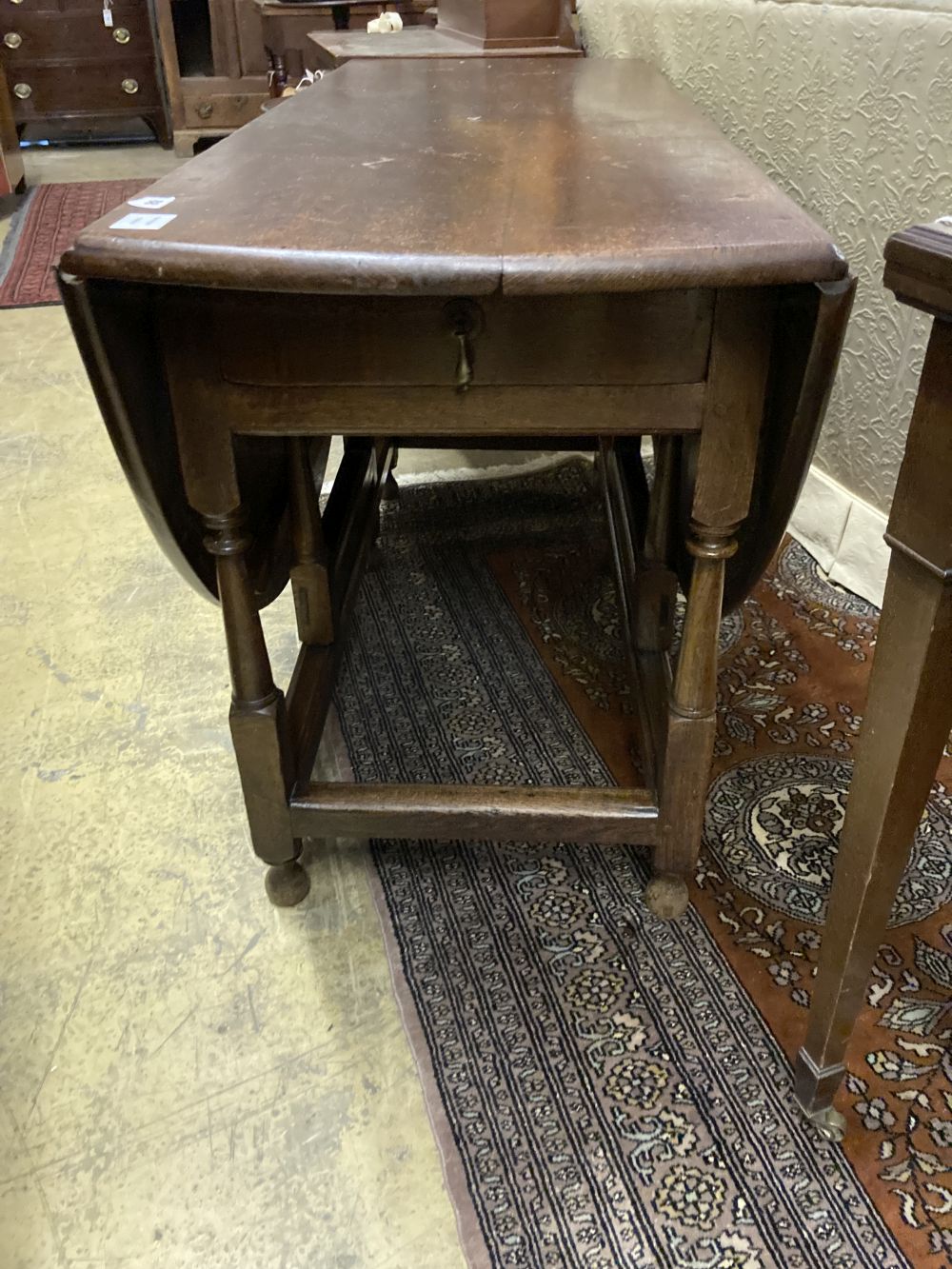 An 18th century oak oval topped gateleg dining table, fitted single drawer, width 130cm depth 50cm height 74cm